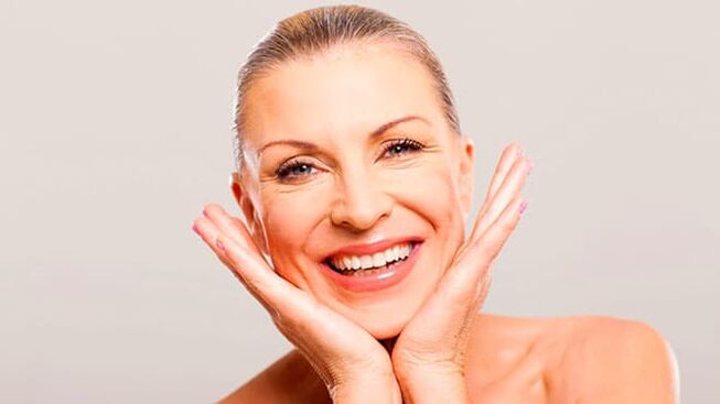 Happy woman in her 50s after facial care